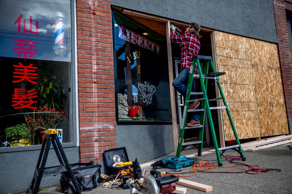 boarding up windows on a businesses