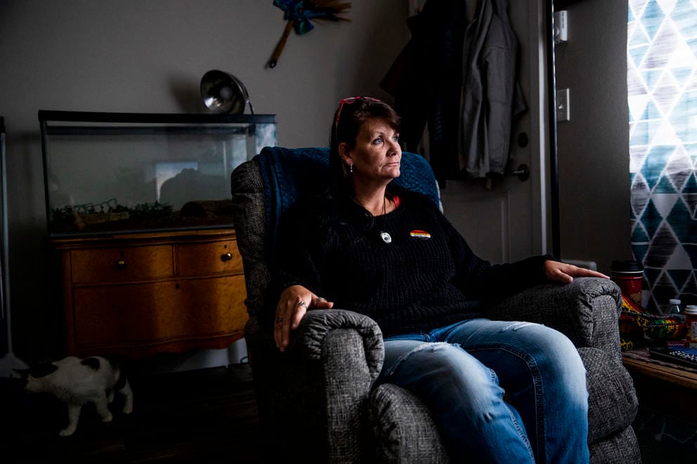 Donna sits on her living room chair 