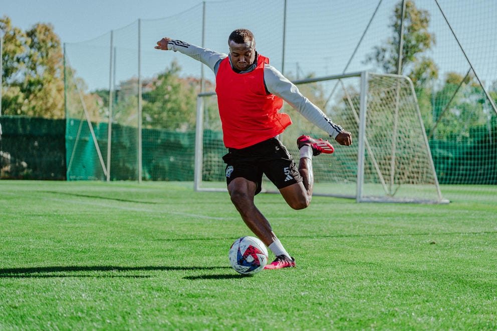 A man kicking a soccerball