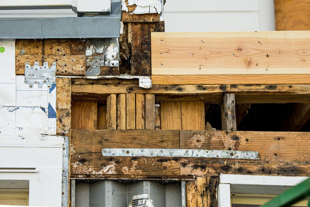 Damage from topical mold is visible above the garage of a home at JBLM