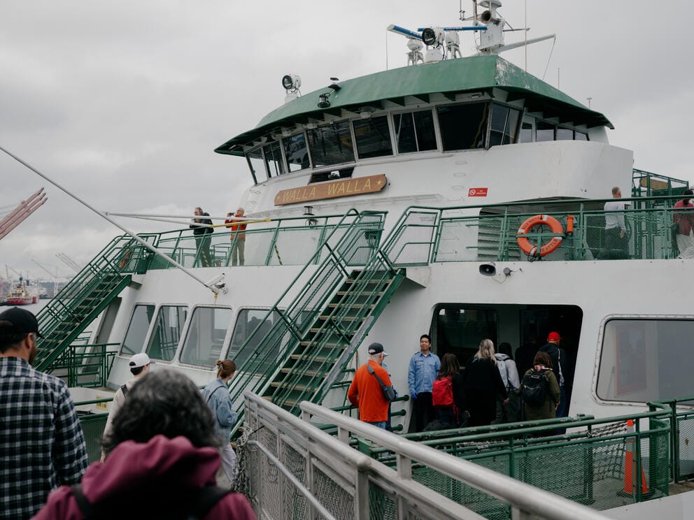 Passengers on the deck of a ferry boat.