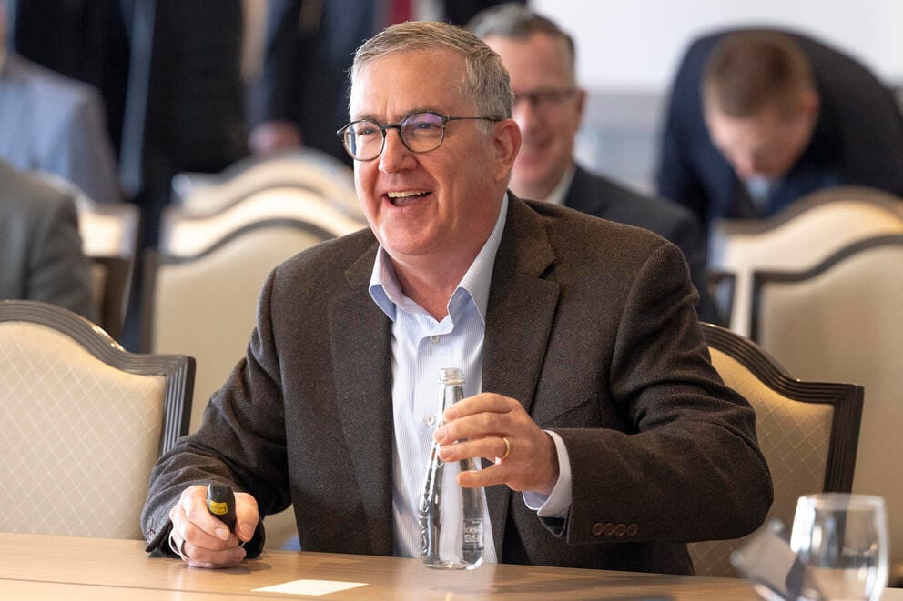 Schulz smiling at a meeting