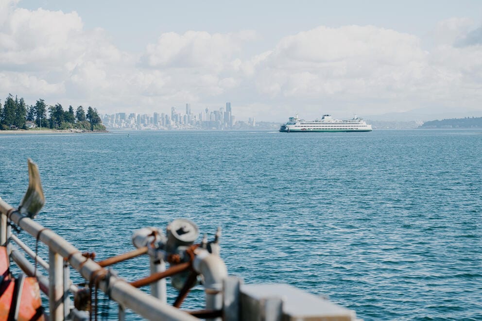 A ferry and the Seattle skyline are seen in the distance across Elliott Bay