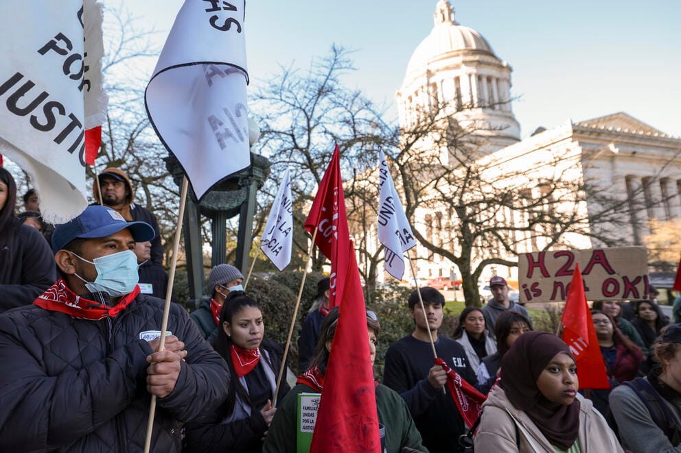 A rally pictured outside the WA state Capitol. Supporters are seen donning red handkerchiefs and flags.