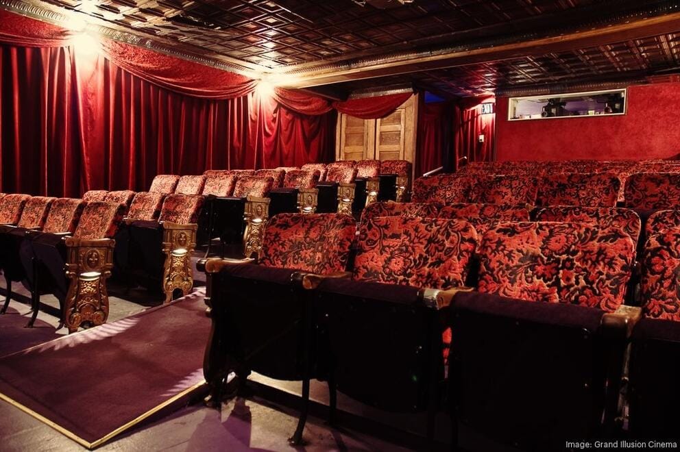 a lush red velvet theater space with low tin ceilings